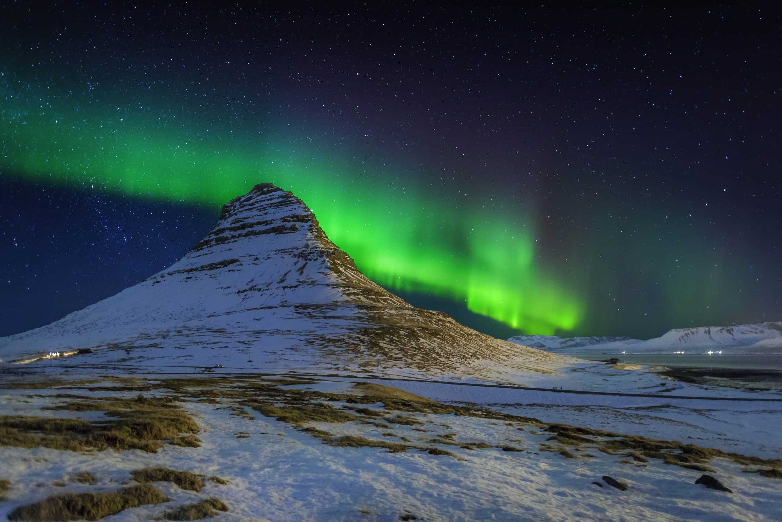 Kirkjufellsfoss under the glow of the Northern Lights, Snaefellsenes Peninsula, Iceland